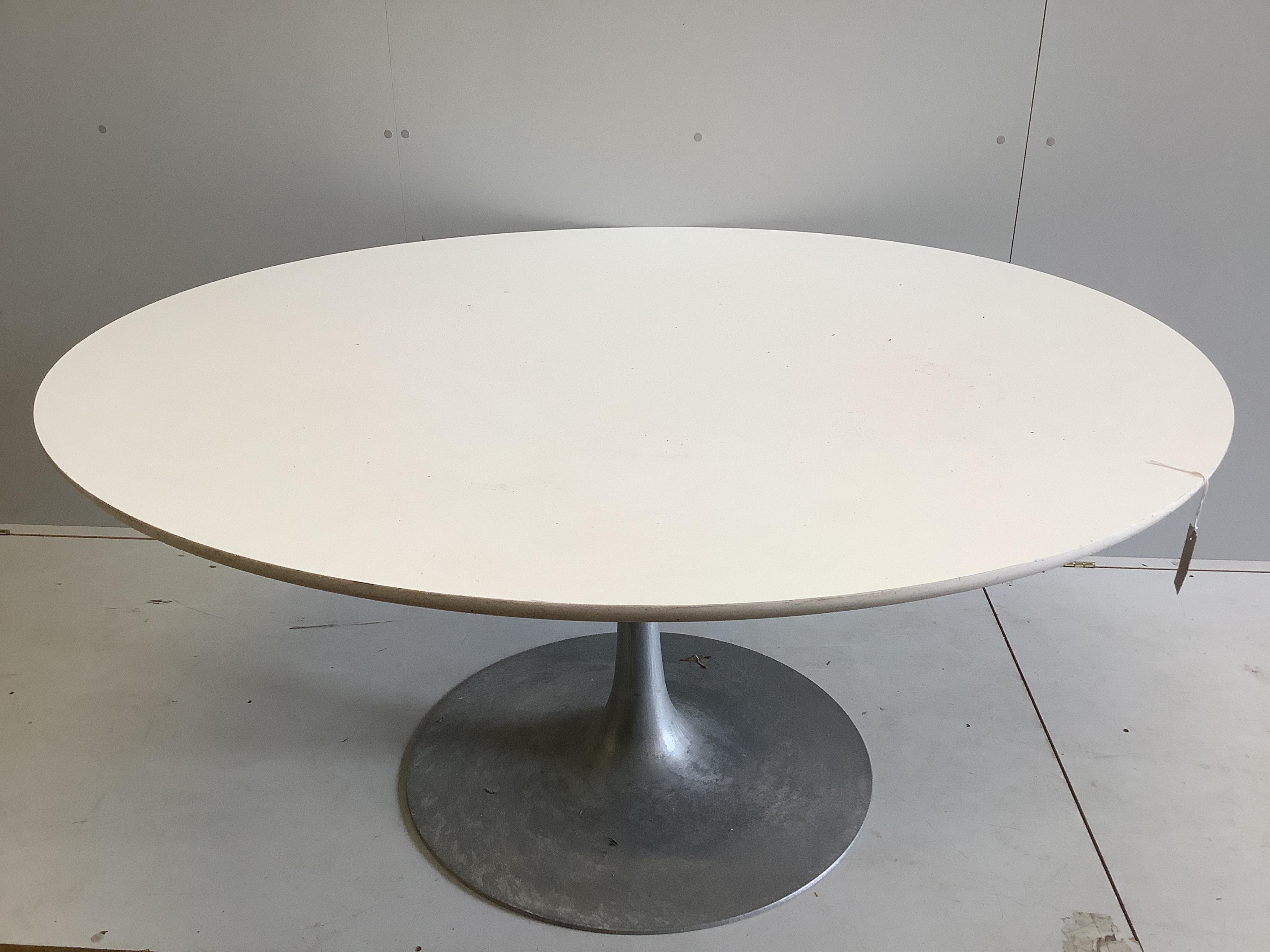 A circular Tulip table, diameter 152cm, height 75cm, and six swivel chairs. Condition - fair to good